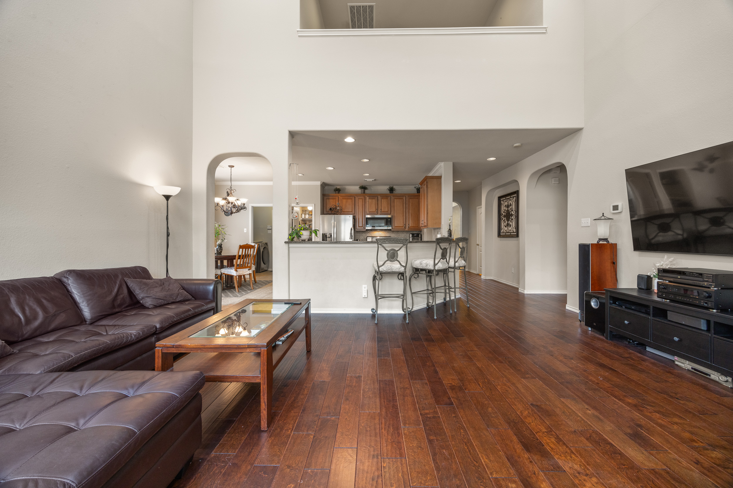 Living room with wood floor and high ceilings